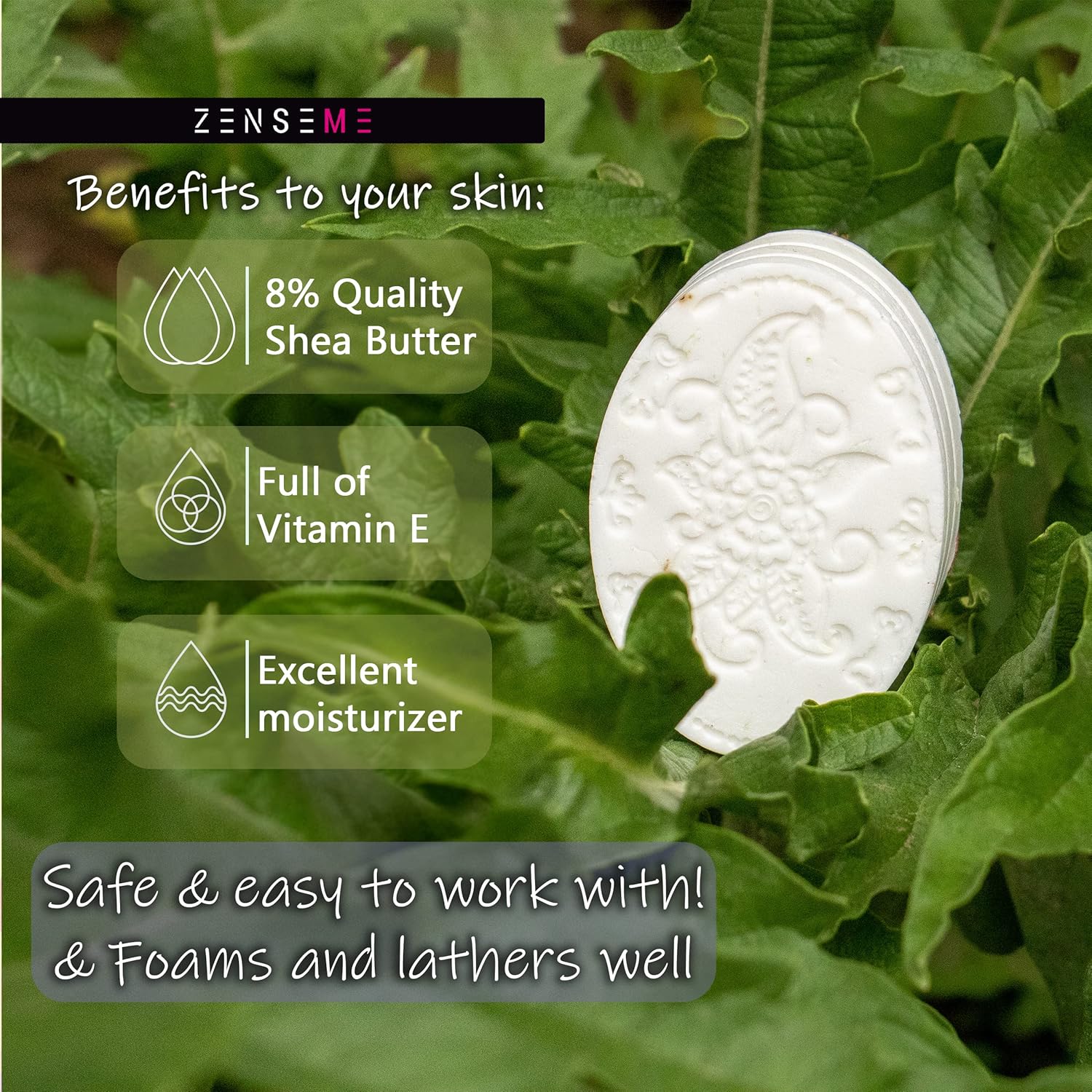 White bar of soap on green leaves 